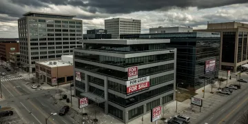 Deserted commercial district with 'for sale' signs, reflecting commercial real estate distress